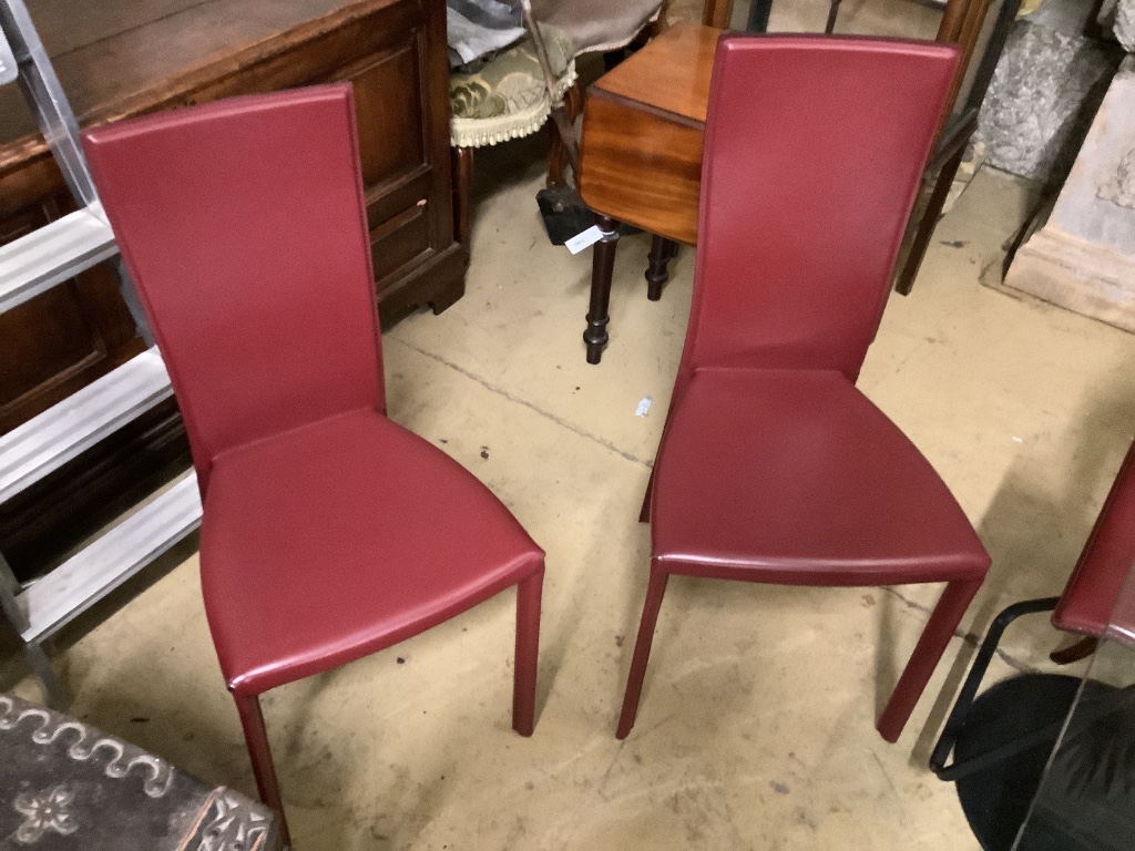 Cattelan Italia, a glass-topped dining table, a set of six red leather-upholstered dining chairs and two matching bar stools